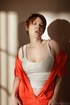 Short-haired redhead takes off her prison jumpsuit