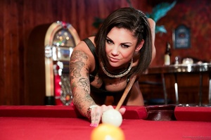 Posing on a pool table from a tatted-up extreme brunette - Picture 3
