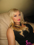 Lavish blonde in black and white dress with long necklace know how to