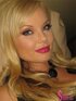 Lavish blonde in black and white dress with long necklace know how to