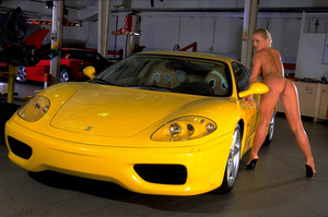 A mature, busty, blonde poses next to a sports car in this photo-shoot - Picture 11