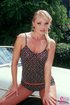 A blonde in a pok a dot skirt shows off her tan, tight body