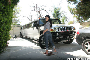 Gorgeous brunette teases with her curves fully clothed near a large SUV - Picture 12
