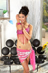 Tall brunette in pink indian outfit teasing on a cam while posing in black