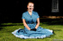 Green eyed redhead in blue dress posing outdoors in blue dress and black