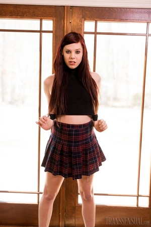 Hot redhead shemale takes her skirt off to show her sexy curves - Picture 2