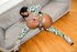 Busty ebony slut in green jerks her black cock on the sofa.