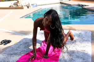 Ebony babe in pink bikini strips and teases by the pool. - Picture 14