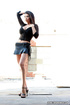 Brunette in skirt does a slow striptease on the rooftop.