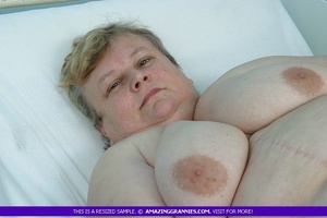 Naked granny teases with her fat body and shows her large breasts and nasty pussy in different poses in a hospital. - Picture 12
