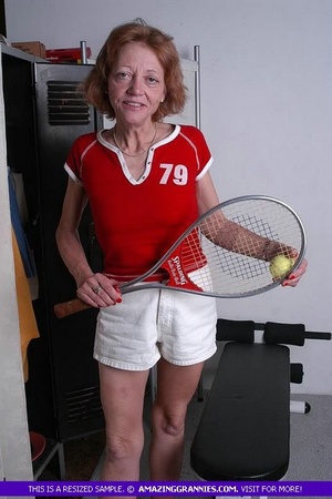 Luscious granny pose her old body while holding a tennis racket before she expose her small tits wearing her red shirt and white shorts. - XXXonXXX - Pic 2