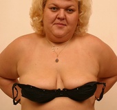 Mature blonde teases with her lusty boobs and foxy body in black gym shirt,