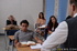 Sexy brunette in her floral print dress gives the other classmates a reason