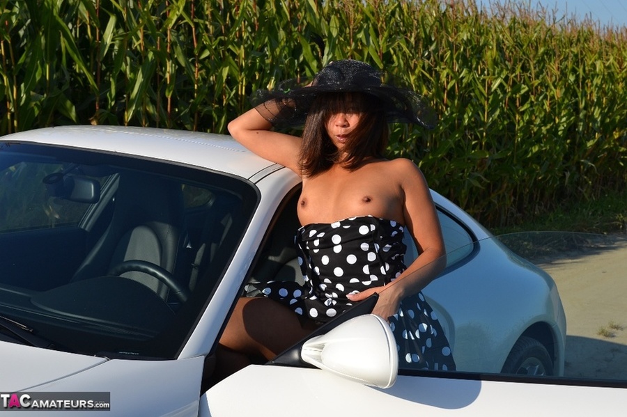 Hot Asian babe poses by an expensive car and strips all of her clothes - XXXonXXX - Pic 7