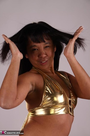 Tanned Asian slut poses rather seductively, while wearing sexy golden underwear - XXXonXXX - Pic 9