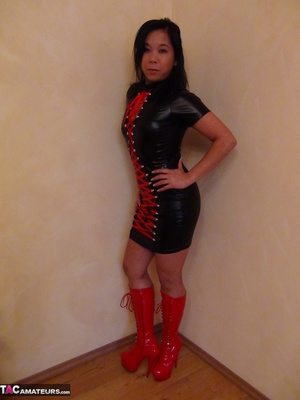 Long legged Asian cutie poses seductively, wearing latex clothes and boots - Picture 2