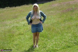 Hot blonde milf exposes her massive melons and shaved pussy in nature - Picture 13