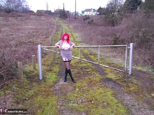 Redhead British slut takes off her clothes in nature to show her large tits - Picture 7