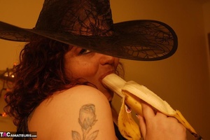 Busty slut is having fun while sucking a banana like it was a real cock - Picture 13