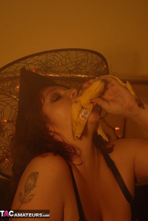 Busty slut is having fun while sucking a banana like it was a real cock - Picture 16