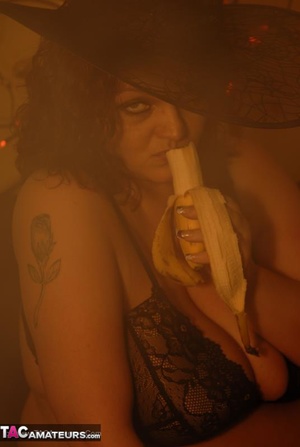 Busty slut is having fun while sucking a banana like it was a real cock - Picture 18