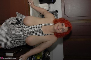 Red haired housewife teases with her large tits and ass in the kitchen - Picture 5