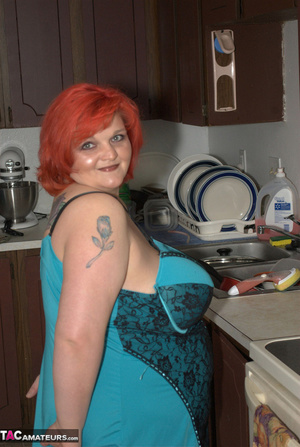 Redhead BBW shows her large butt and massive tits in the kitchen - Picture 1