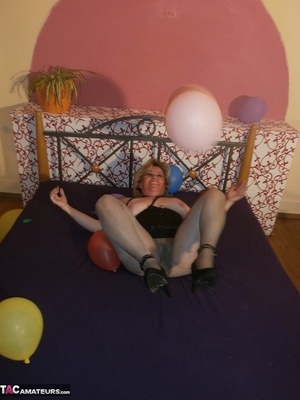 Blonde cougar plays with balloons and shows her massive tits to the cam - XXXonXXX - Pic 10