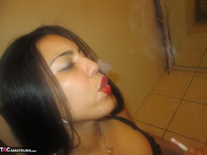 Hot Latina with big jugs strips her clothes while smoking a cigarette - Picture 7