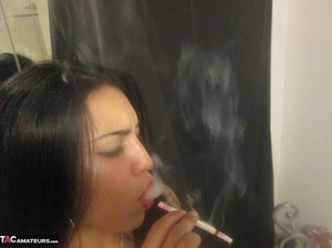 Hot Latina with big jugs strips her clothes while smoking a cigarette - Picture 10