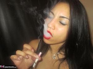 Hot Latina with big jugs strips her clothes while smoking a cigarette - Picture 13