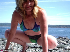 This blonde tramp in a bikini shows off her slutty body as she poses beach-side - XXXonXXX - Pic 2