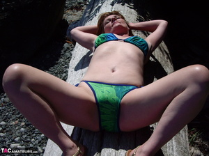 This blonde tramp in a bikini shows off her slutty body as she poses beach-side - Picture 4