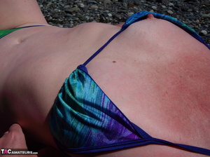 This blonde tramp in a bikini shows off her slutty body as she poses beach-side - Picture 5