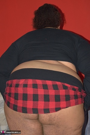 A fat, ebony, slut in a plaid skirt rubs her wet pussy with a brush handle - Picture 5