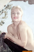 Meaty blonde princess takes off her clothes to expose her massive breasts