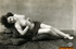 This petite beauty poses seductively on the back of a taxidermy tiger