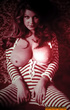 This sultry blonde pouts her lips seductively and displays her large breasts