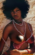 Tempting black gal wearing white shorts and pearl necklace embraces her