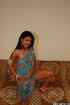Petite body babe with dark hair teasingly posing in blue indian outfit