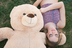 Blonde slut shows her long legs having fun with a stuffed bear. - Picture 1