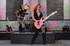 Two brunette rock stars sharing a double-sided dildo