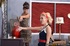 Two busty pin-up lesbians strapon-fucking each other
