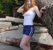 Alluring redhead displays her banging body before she pulls down her blue