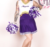 Pony tail colorful brunette in blue and white cheerleader outfit flaunts