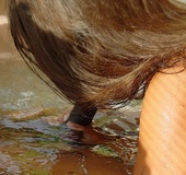 Busty tattooed honey brunette with hairy pussy blows black cock in water