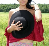 Dark hair cutie in black hat and red top shows tits and hairy cunt outdoors