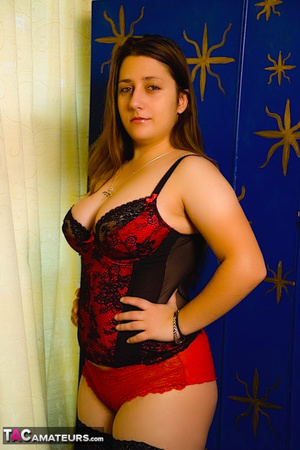 Cute chick displays her chubby body in red and black nighty, black stockings and high heels reveals her luscious boobs then strips down her red panty, spreads wide and drills her twat with a red dildo. - Picture 8