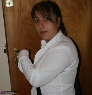 Teen babe with chubby body in white blouse, gray and red skirt, white socks and black and white rubber shoes goes into her step dad's bedroom and reads a porn magazine. - XXXonXXX - Pic 1