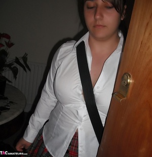Teen babe with chubby body in white blouse, gray and red skirt, white socks and black and white rubber shoes goes into her step dad's bedroom and reads a porn magazine. - Picture 2